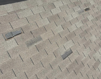 Camouflage Roofing inspecting a roof in Yukon