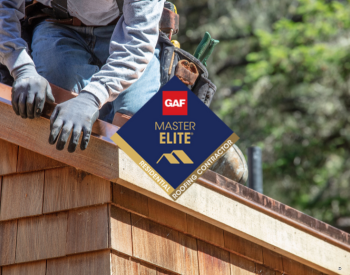 Roofer repairing a roof in Shawnee with GAF Master Elite Certification badge